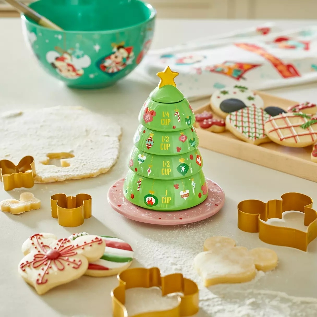 a stack of measuring cups that look like a disney christmas tree