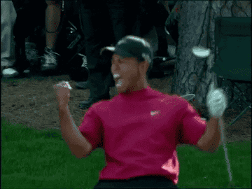 Tiger Woods celebrates on the golf course.