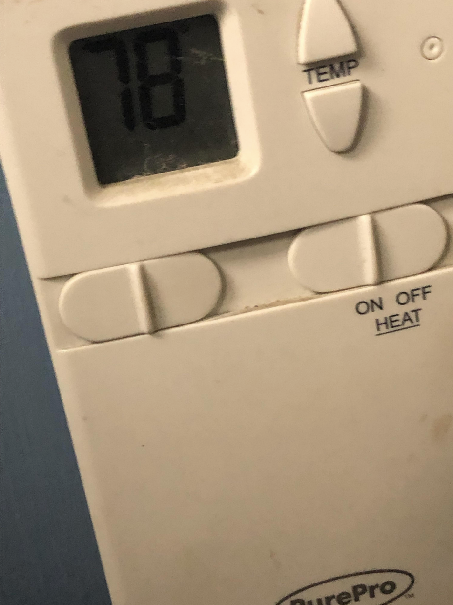 Closeup of a thermostat reading &quot;78&quot; degrees