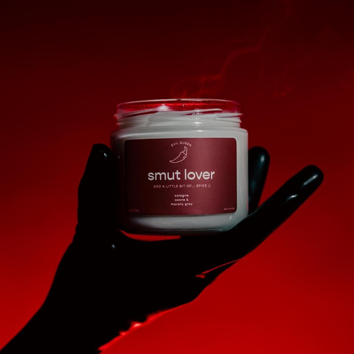 a candle with a maroon label that says &quot;smut lover add a little bit of spice&quot;