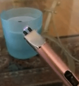 gif of reviewer lighting a candle using the pink electric lighter