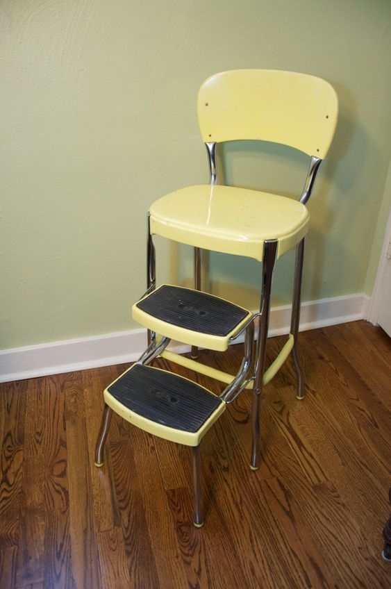 A metal armless chair with a footrest
