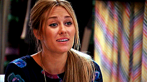 Lauren Conrad putting her hands beneath her chin, as if saying &quot;awee&quot;