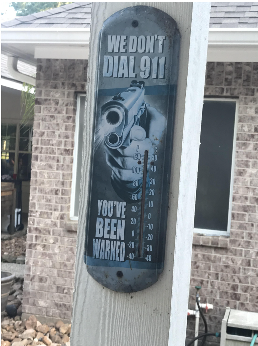 photo of a gun pointed and the sign reads, we don&#x27;t dial 911, you&#x27;ve been warned