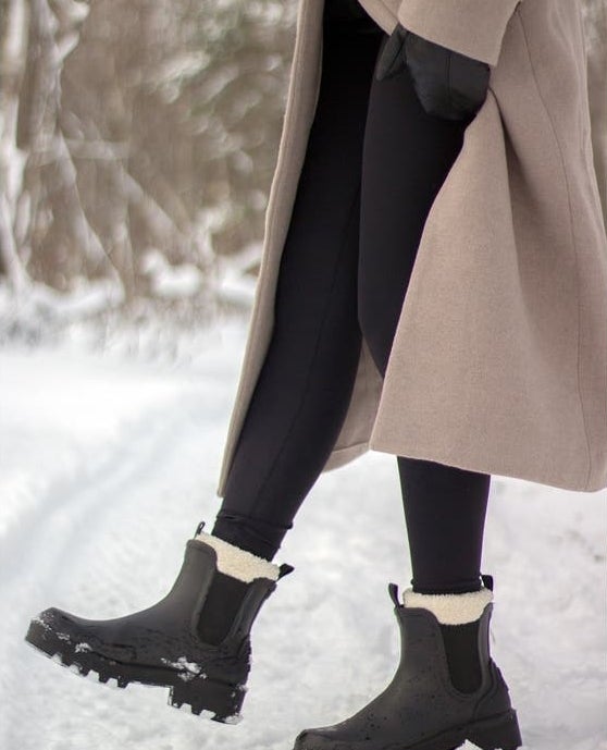the boots in black with a cream faux shearling interior