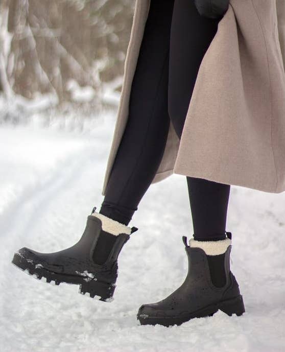 the boots in black with a cream faux shearling interior