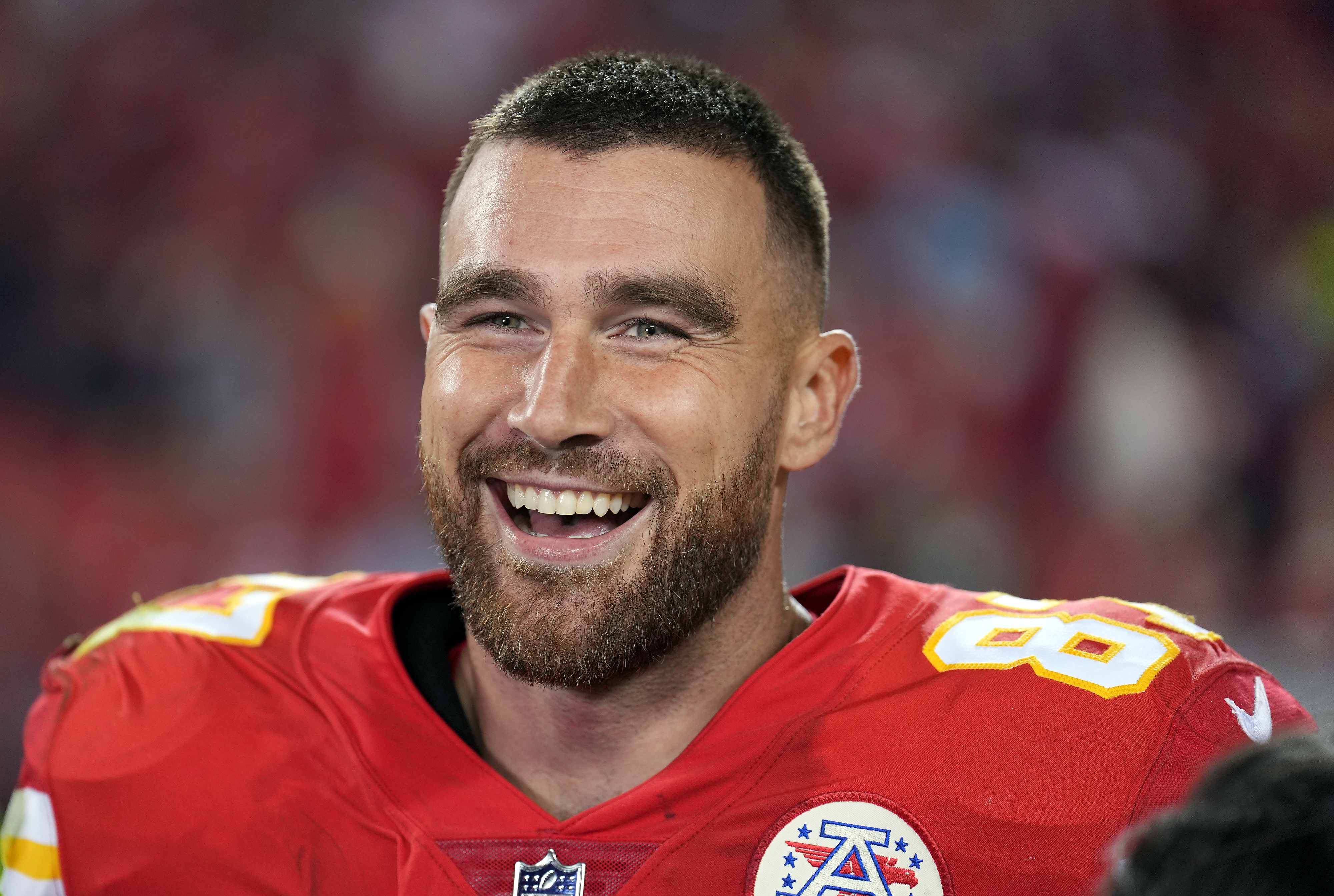 Close-up of Travis smiling and wearing his NFL uniform