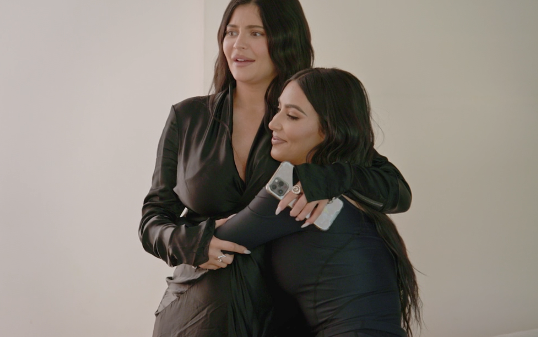 Kylie and Kim embracing