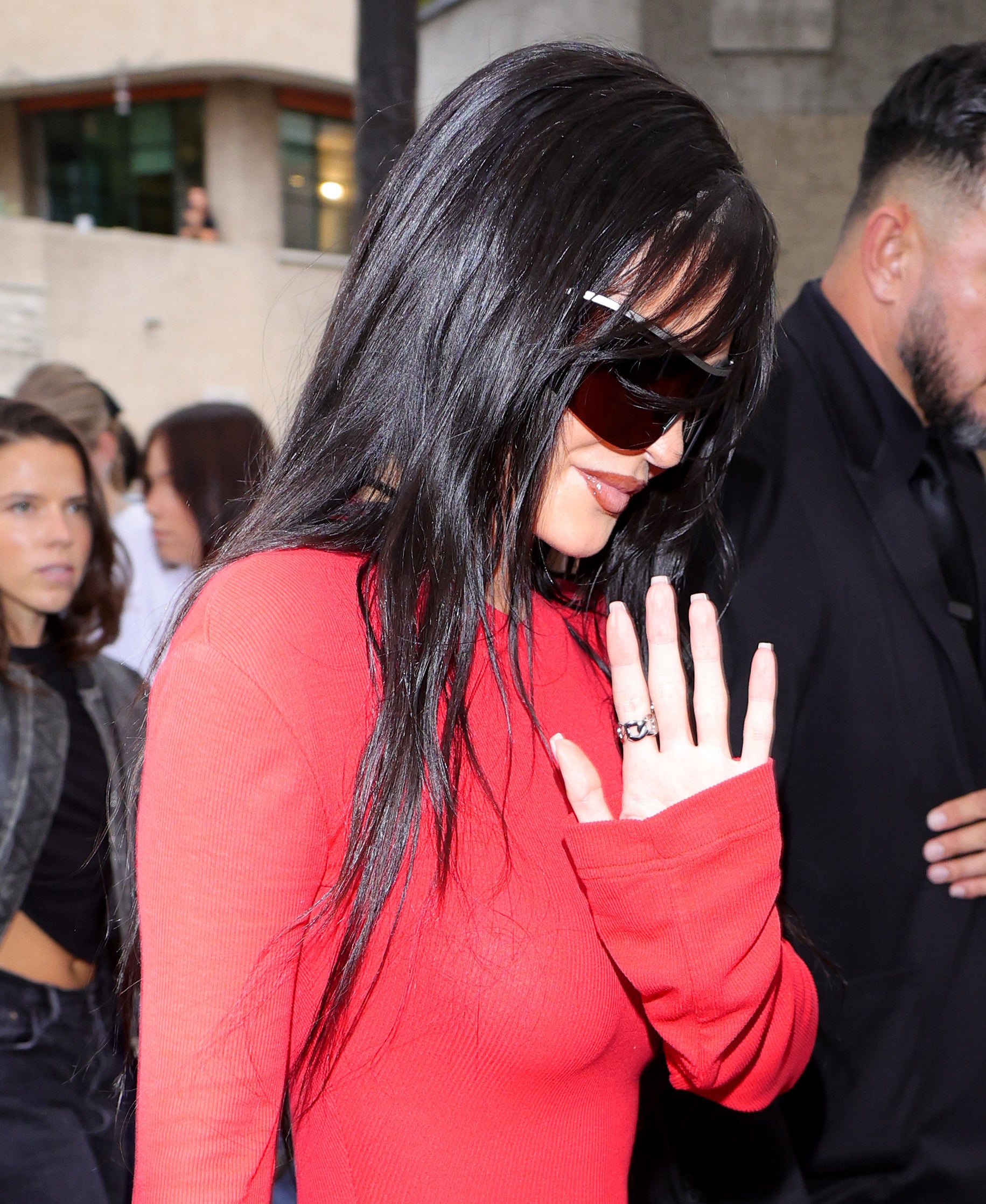 Close-up of Kylie waving and wearing sunglasses