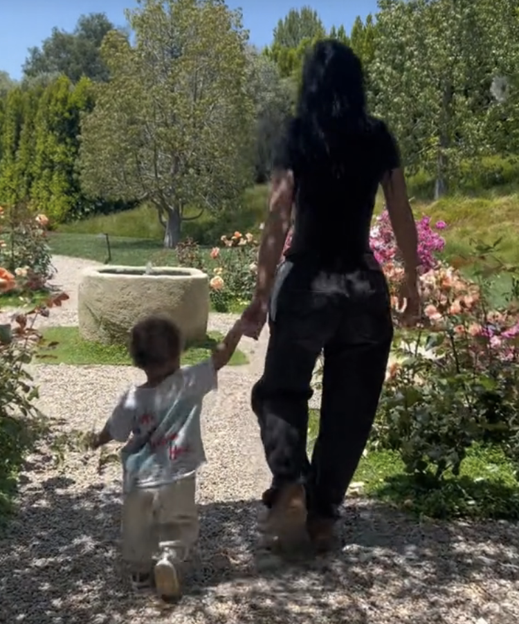 Kylie with one of her children walking together