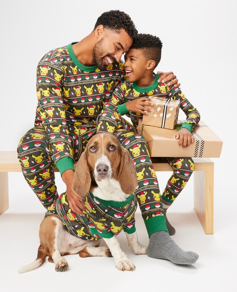 a dad and child and dog in matching pikachu pajamas