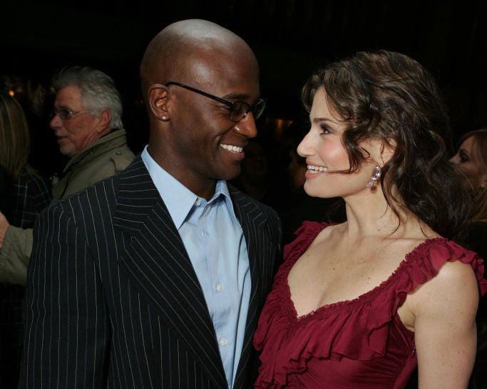 Close-up of Idina and Taye smiling at each other