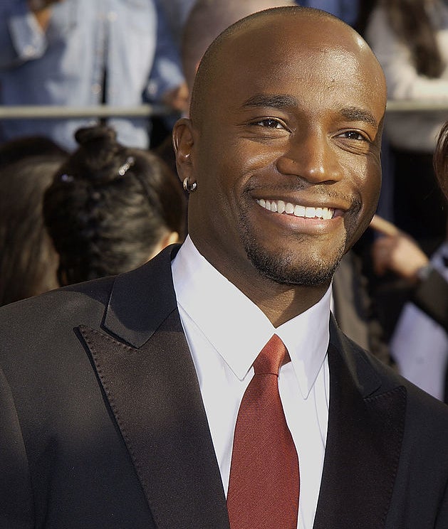 Close-up of Taye smiling at a media event