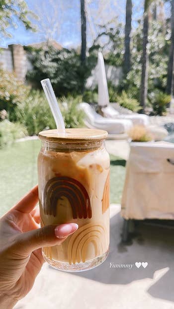 a glass coffee cup with tan and brown rainbows on them