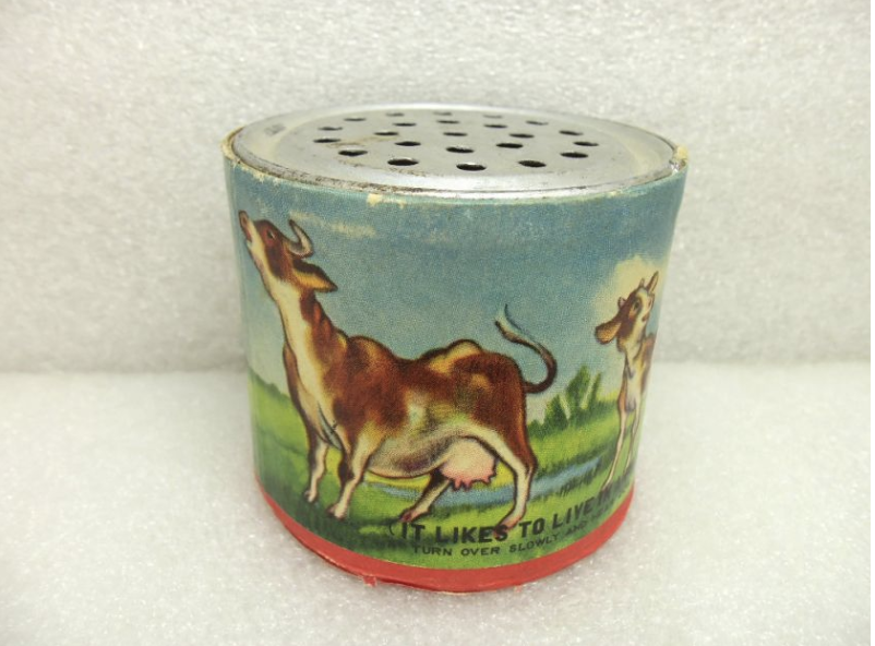 Vintage pocket noise-maker mooing-cow tin toy in the shape of a can