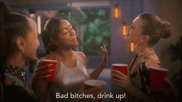 Girls from the cast of &quot;Grown-Ish&quot; toasting red solo cups while one says &quot;bad bitches, drink up&quot;
