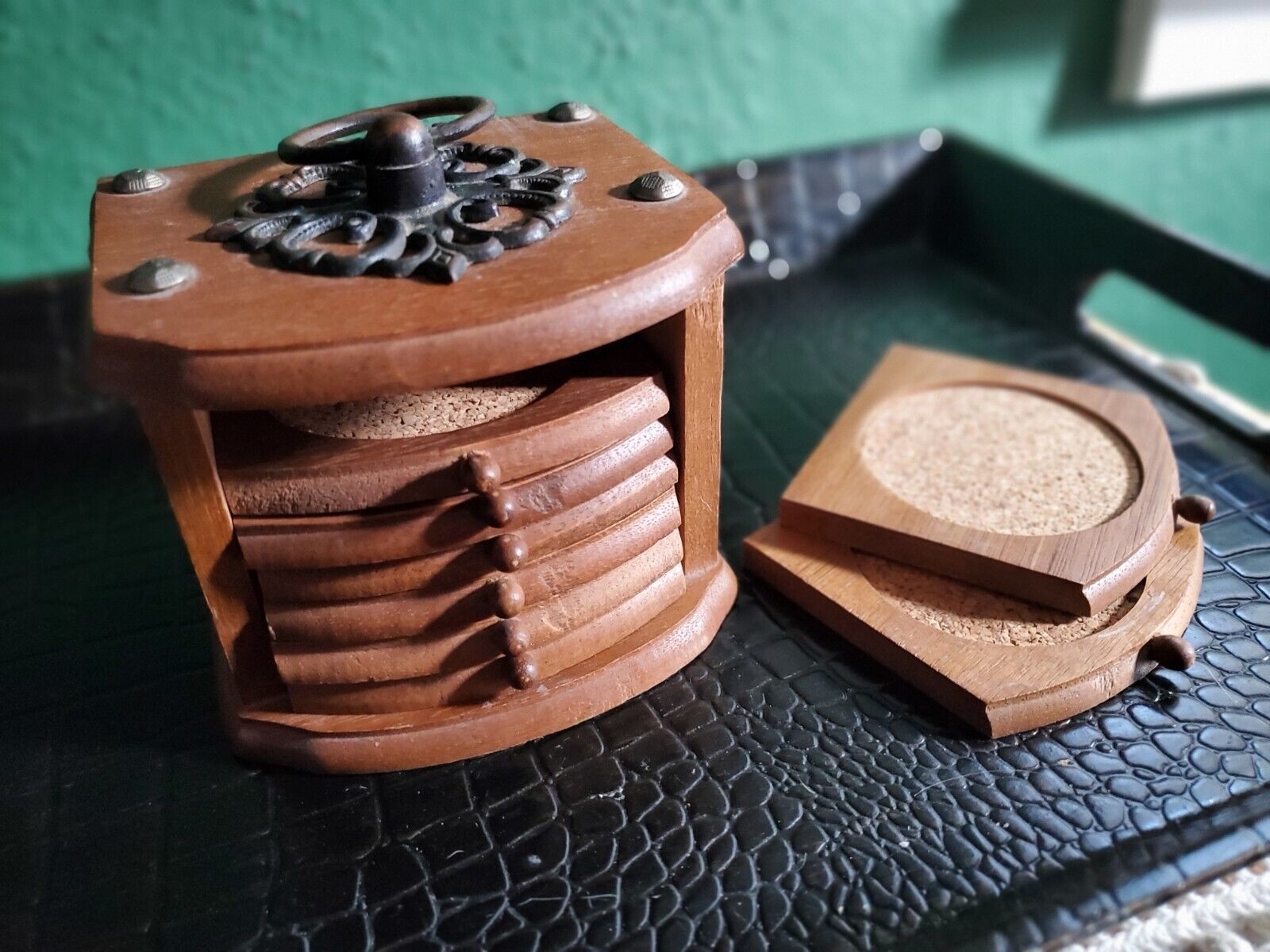 A wood holder containing cork coasters