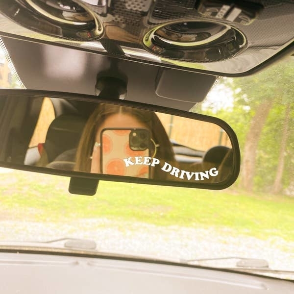 the wavy &quot;keep driving&quot; sticker on a rear mirror