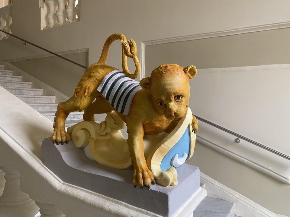 An animal statue near some stairs