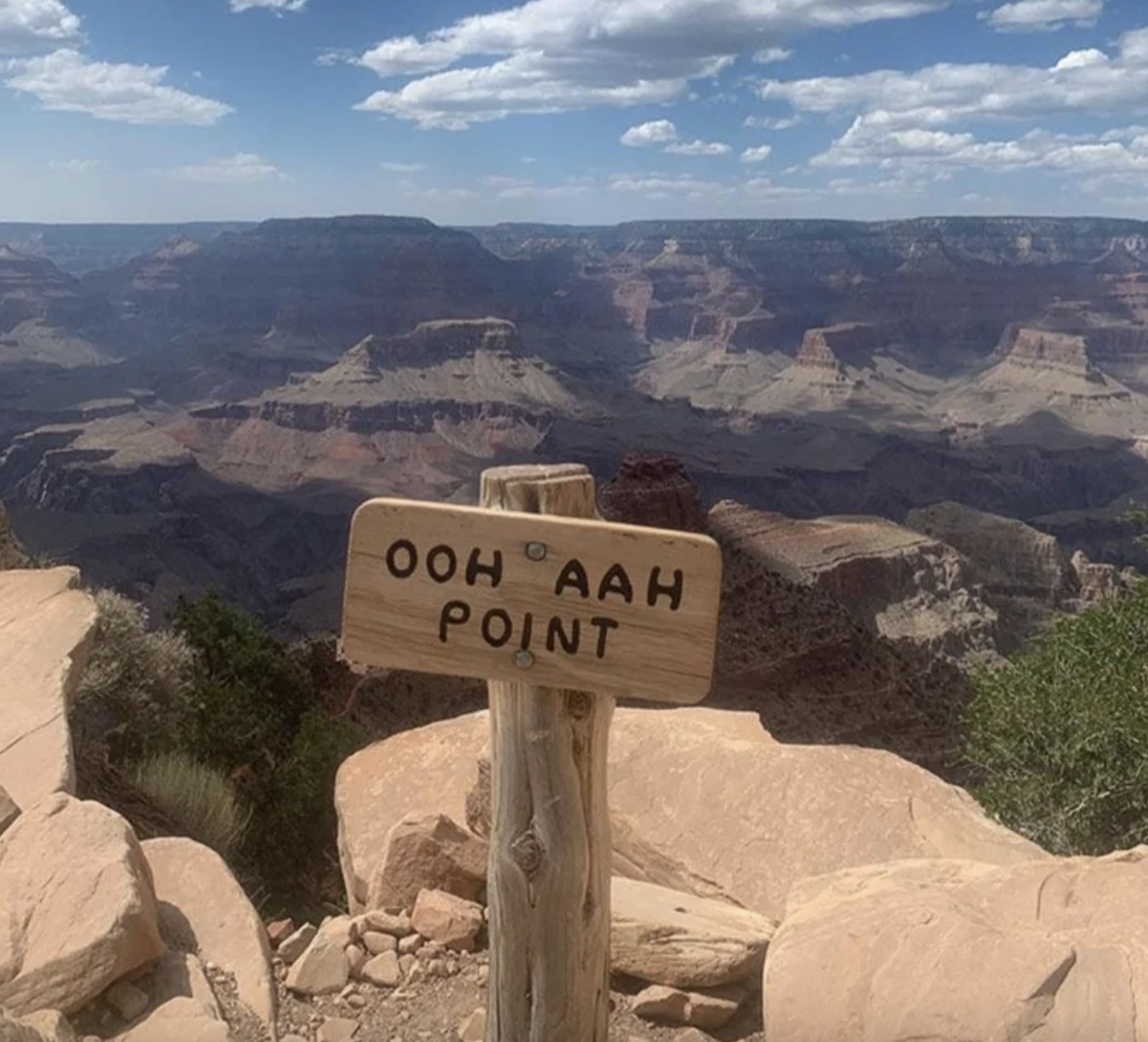 top of the mountain has a sign that says, ooh aah point