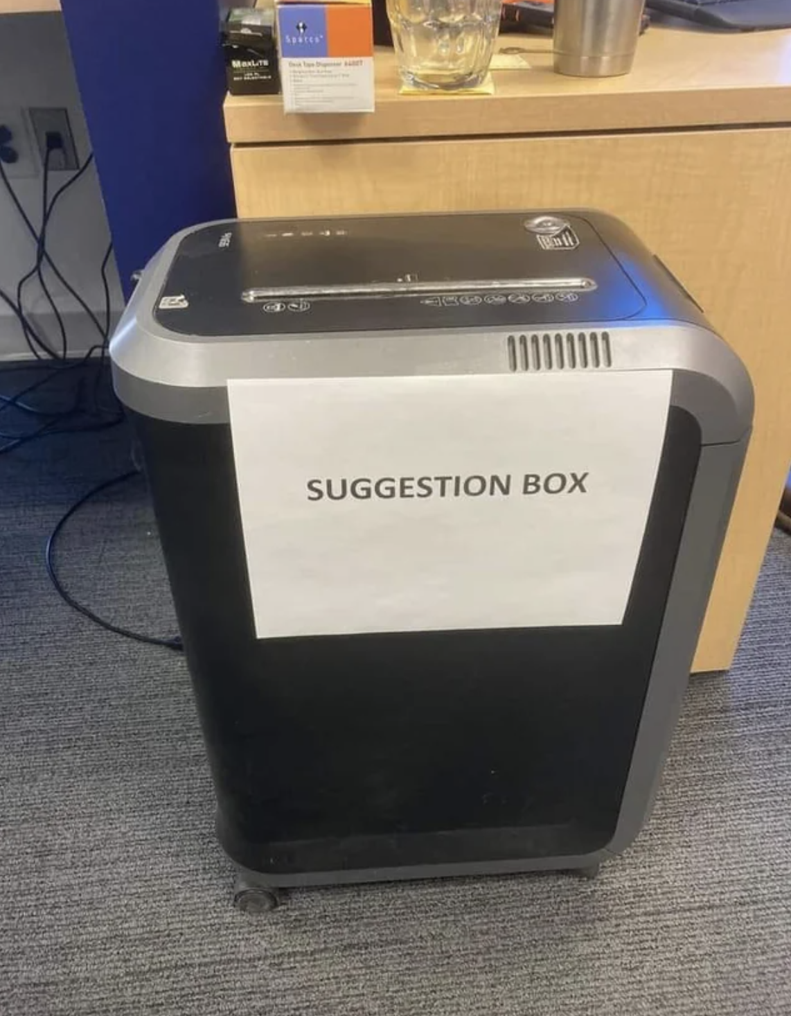 suggestion box note taped to the paper shredder