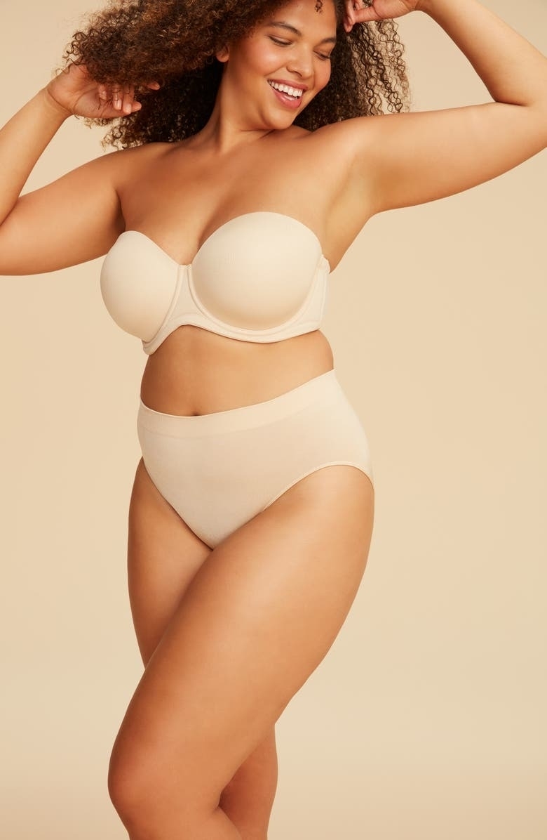 model wearing beige strapless bra and matching underwear