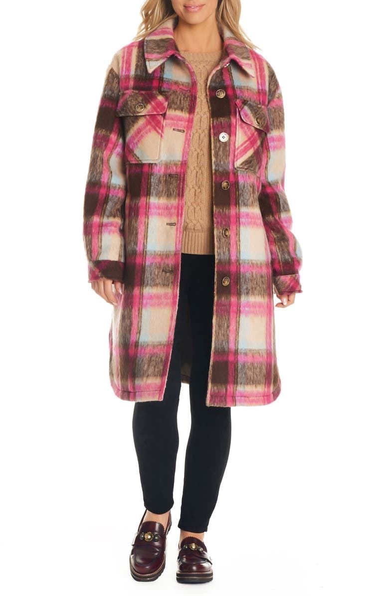 the model wearing the pink and brown patterned shacket