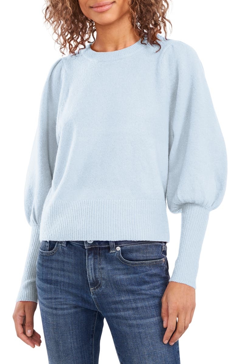 a model wearing the sweater in light blue