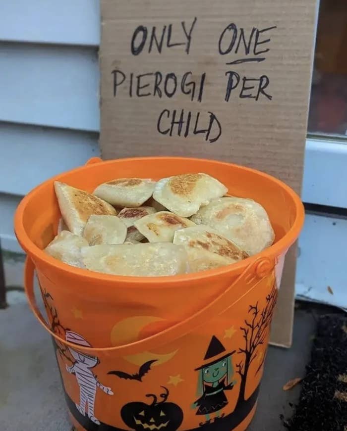 only one pierogi per child next to a bucket of pierogis