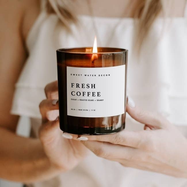 an amber glass candle that smells like fresh coffee