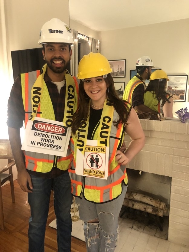 Two people wearing caution and construction clothing