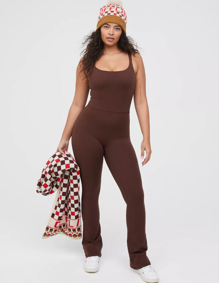 model in a dark brown one piece pant suit and sneakers