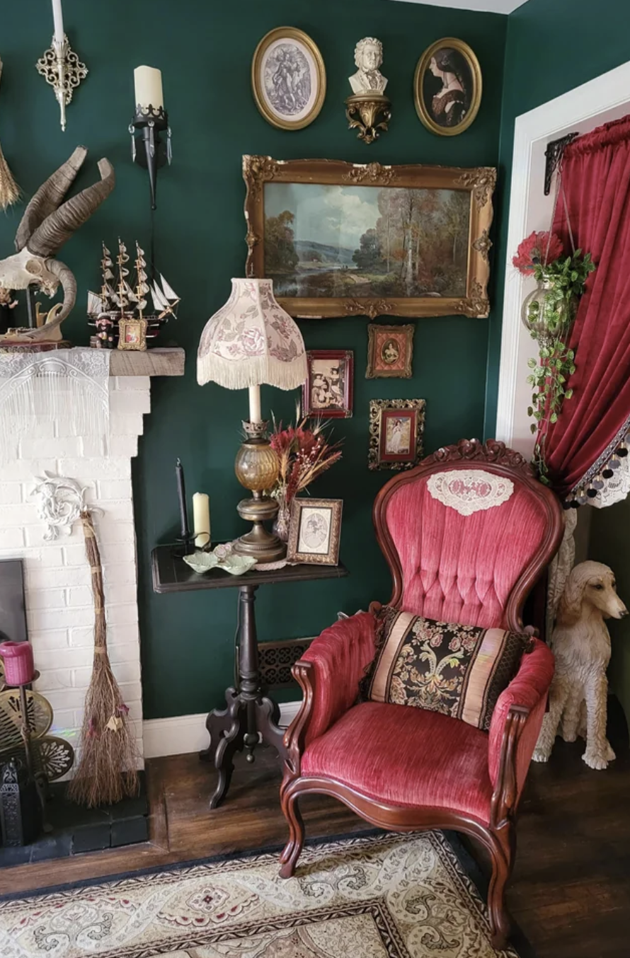 This Victorian-style gothic living room features a red armchair and various trinkets
