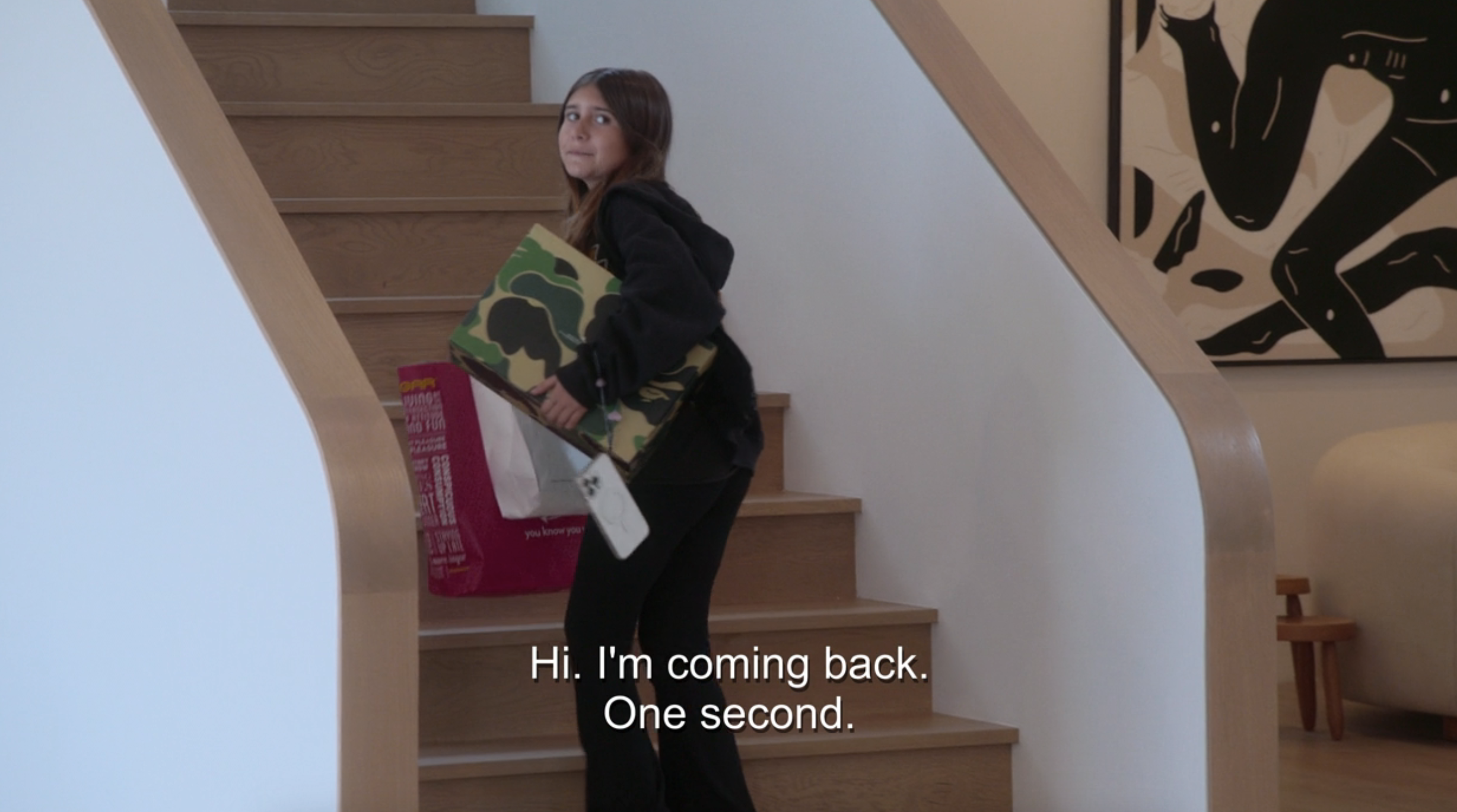 Penelope on the stairs with caption, &quot;Hi, I&#x27;m coming back, one second&quot;