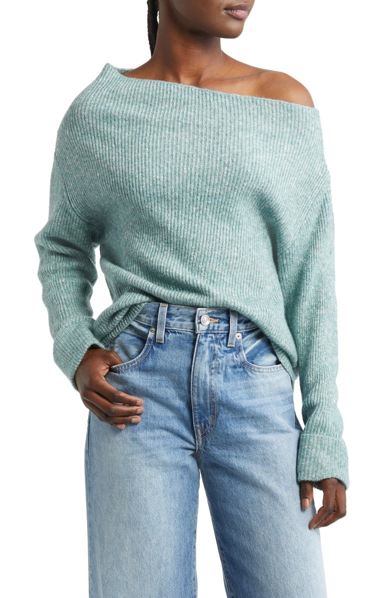 the model wearing the sweater in a light green