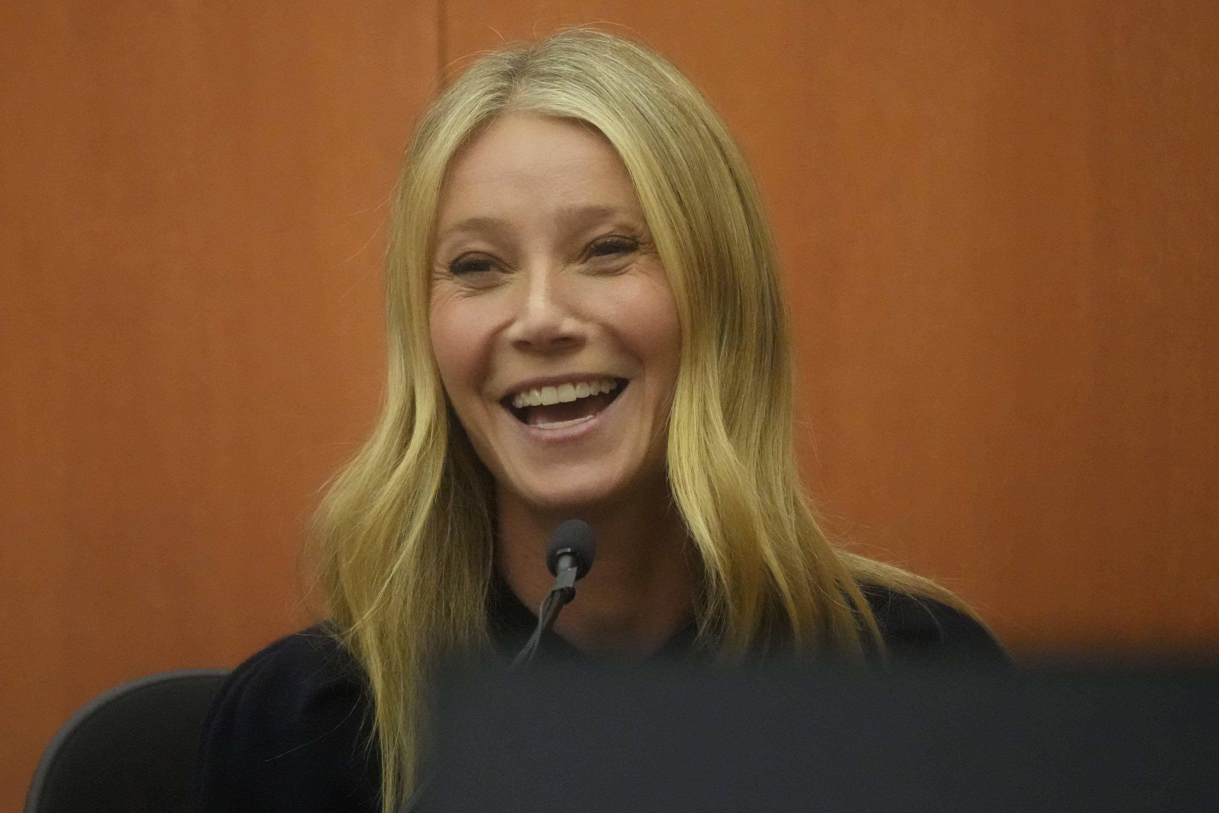 Close-up of Gwyneth smiling in court
