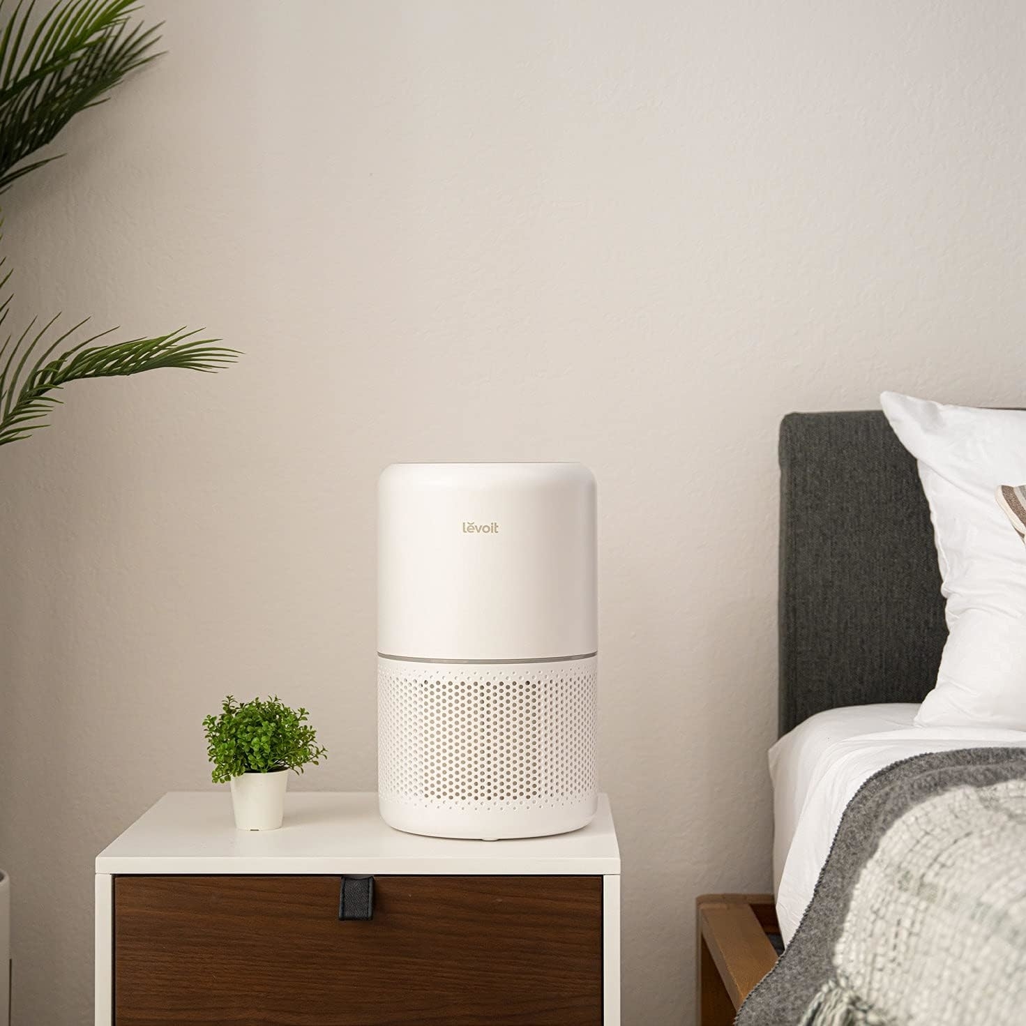 the levoit air purifier on a night stand