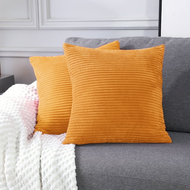 two of the orange corduroy pillows