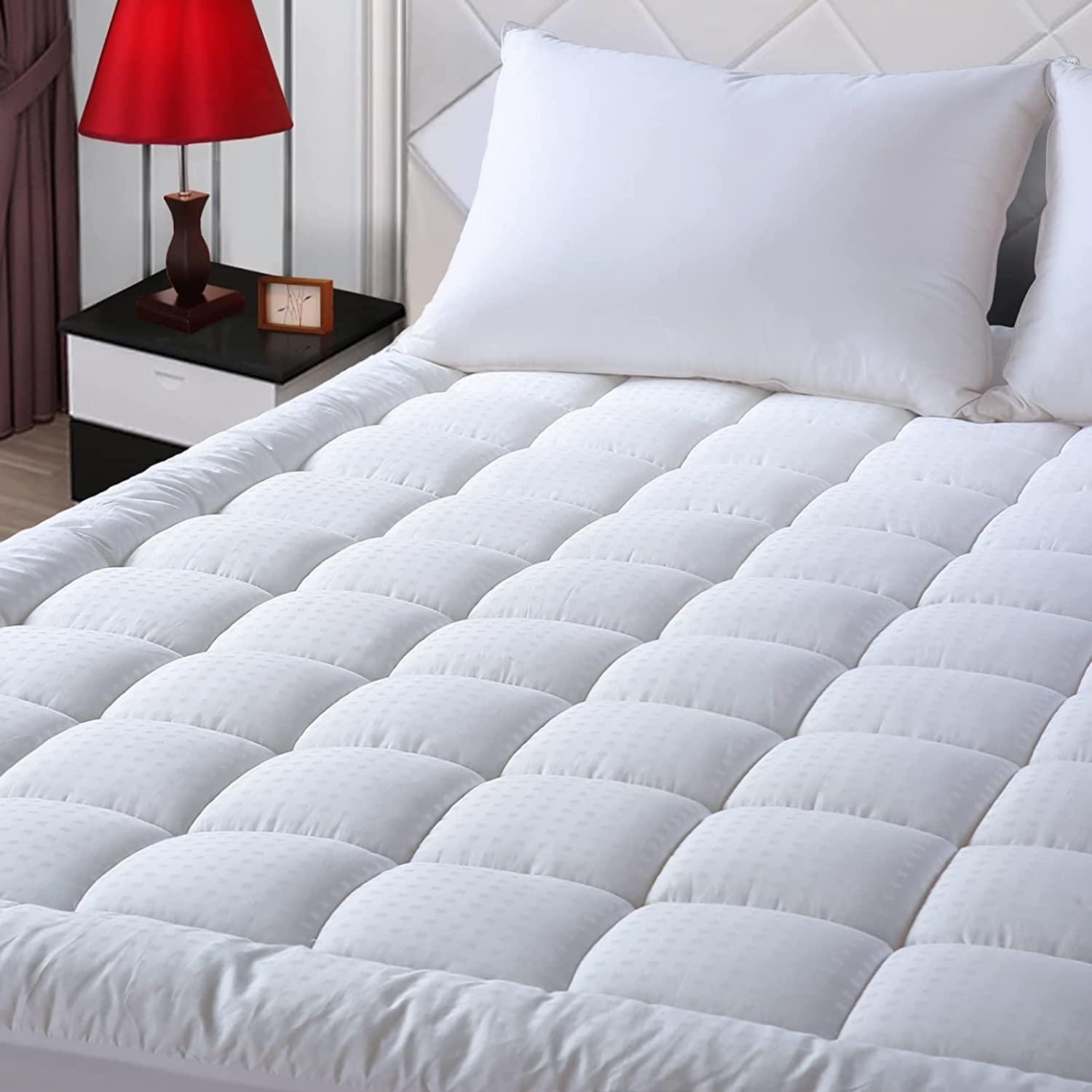 White quilted mattress cover on top of a bed