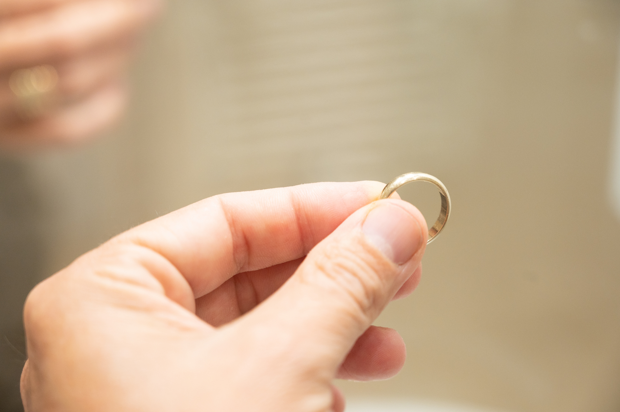 Someone holding a wedding band