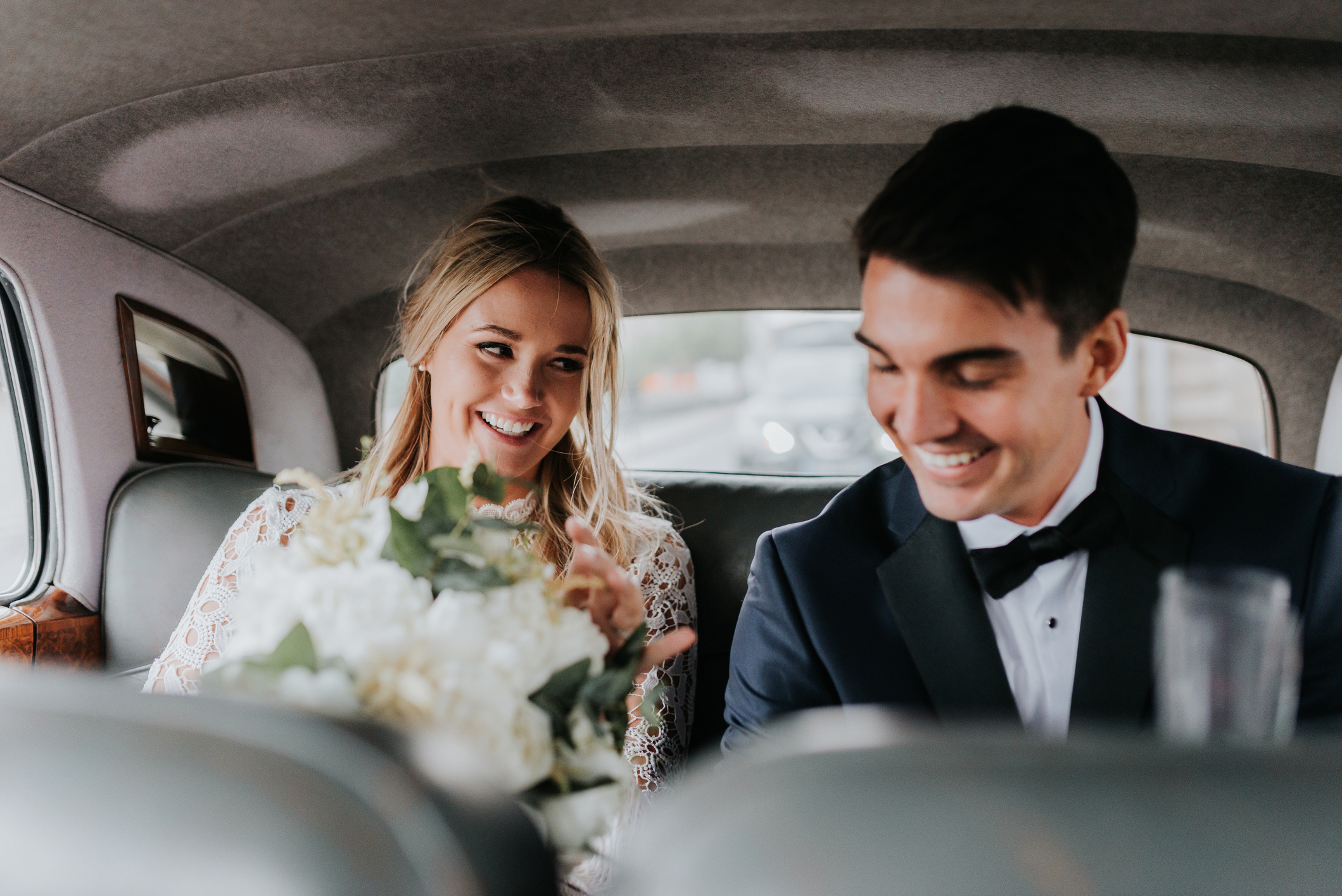 Newlyweds in the back of a car