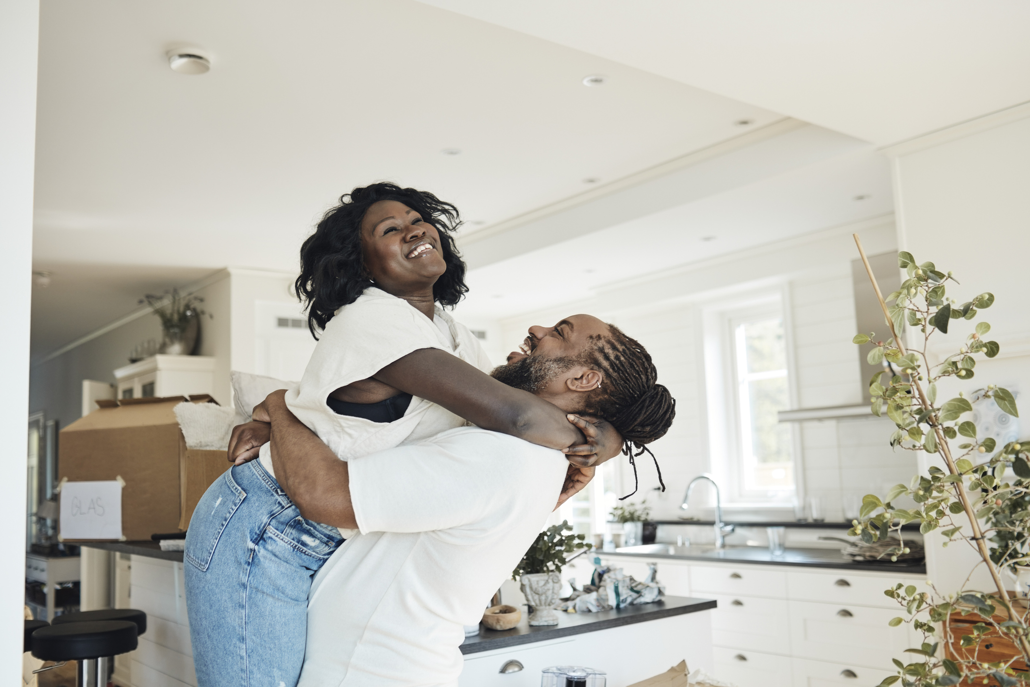 A man lifting his partner while both smile