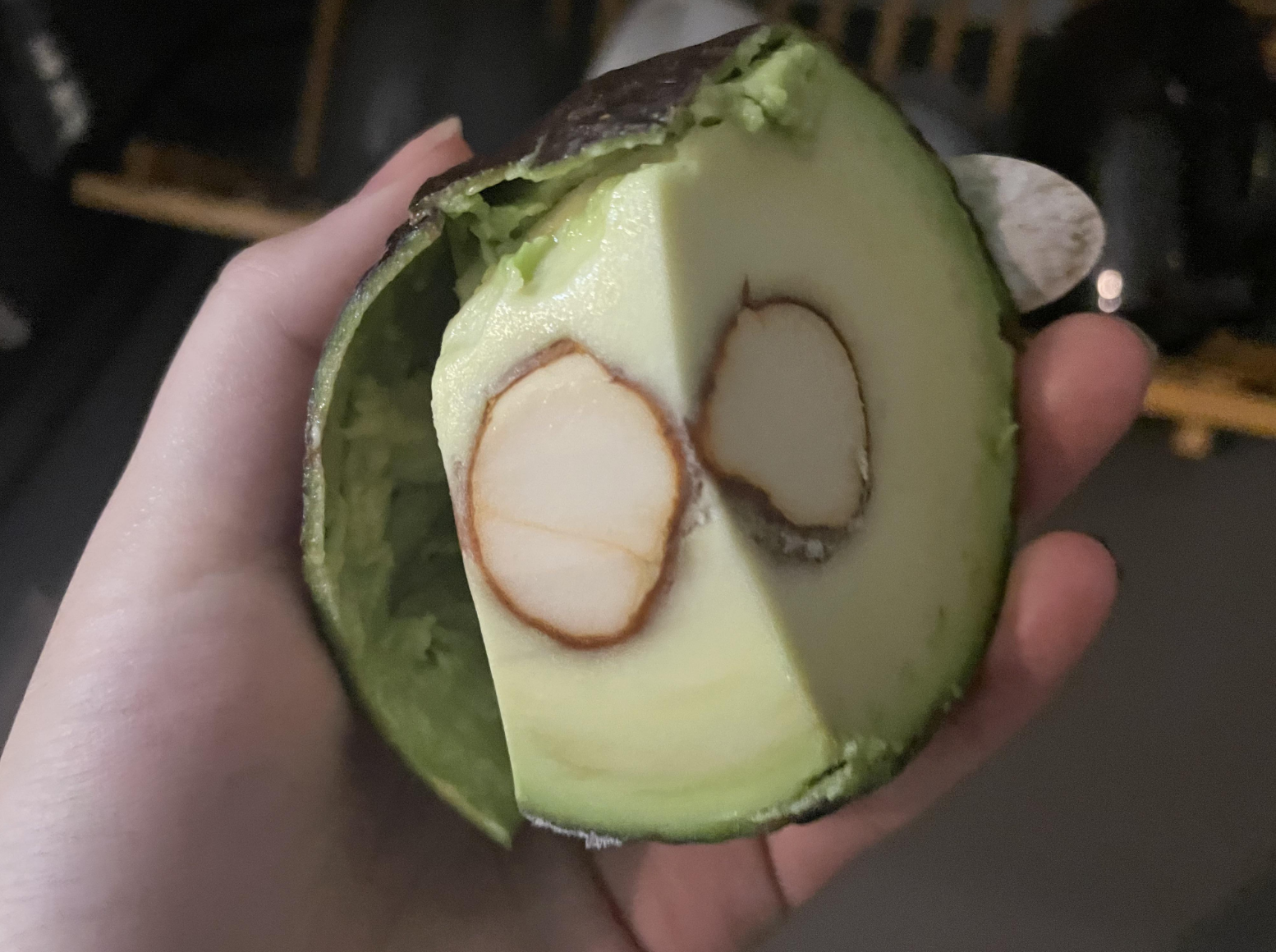 An avocado cut with the pit attached