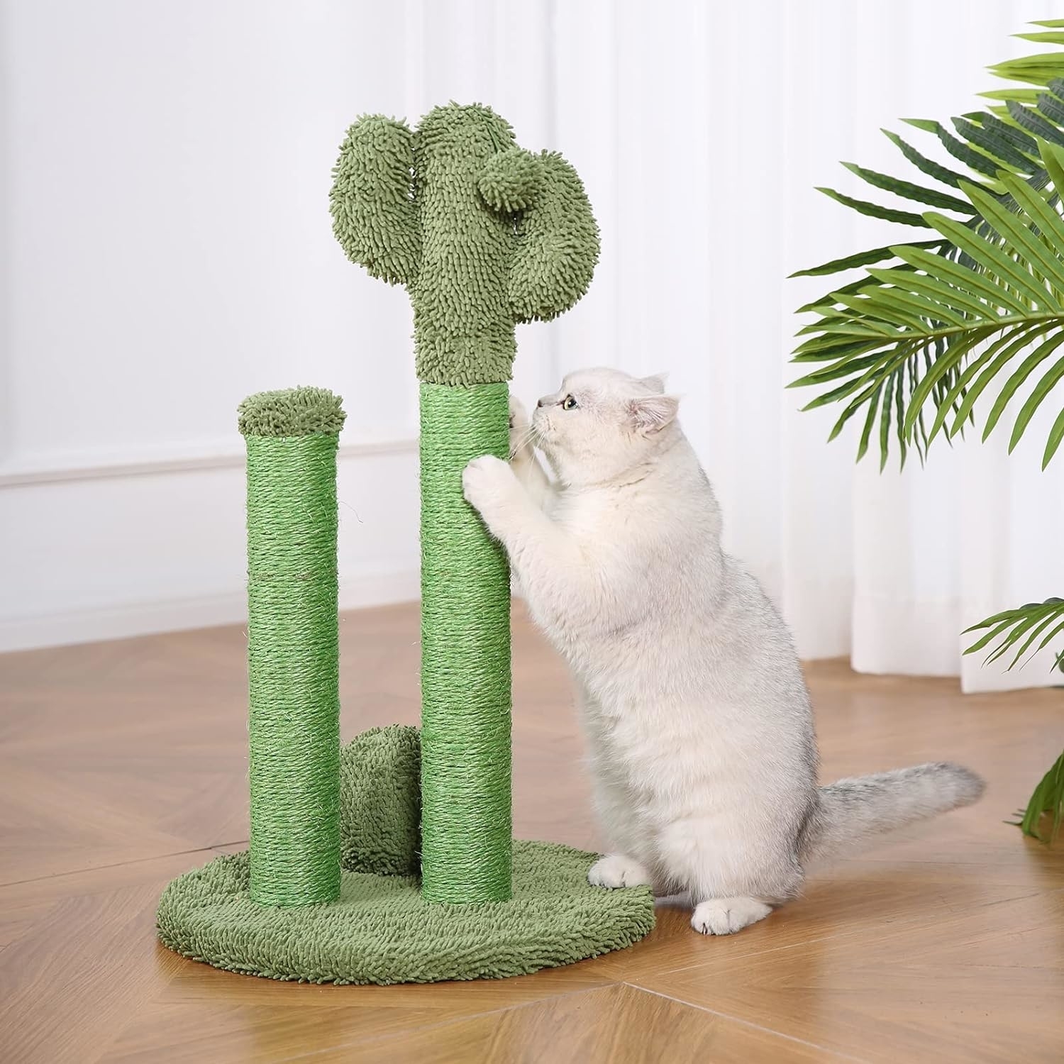 A fluffy white cat scratching the green, cactus cat scratcher