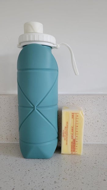 The water bottle next to a half stick of butter