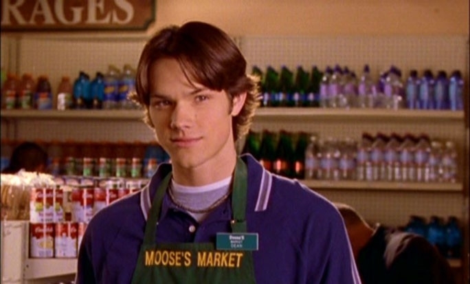 Dean smiles slightly while wearing a Moose&#x27;s Market apron