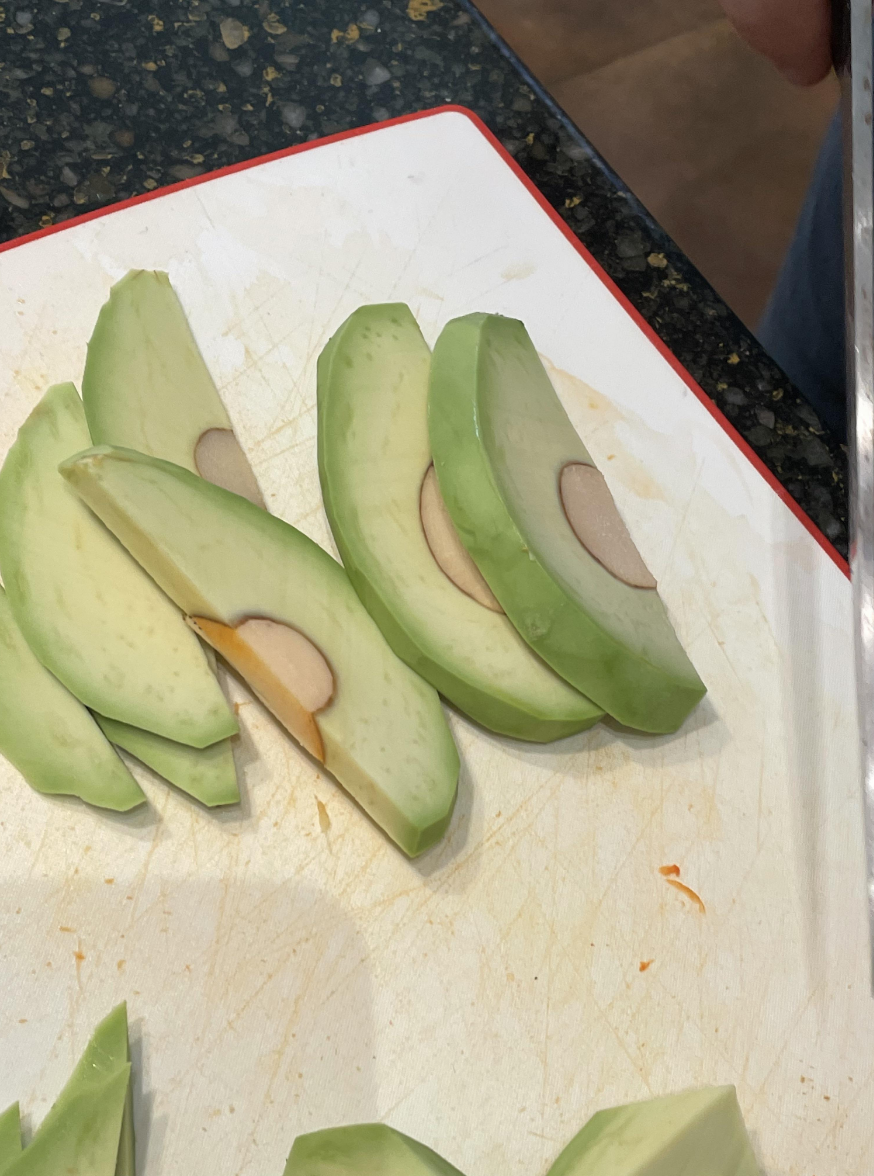 An avocado cut with the pit attached