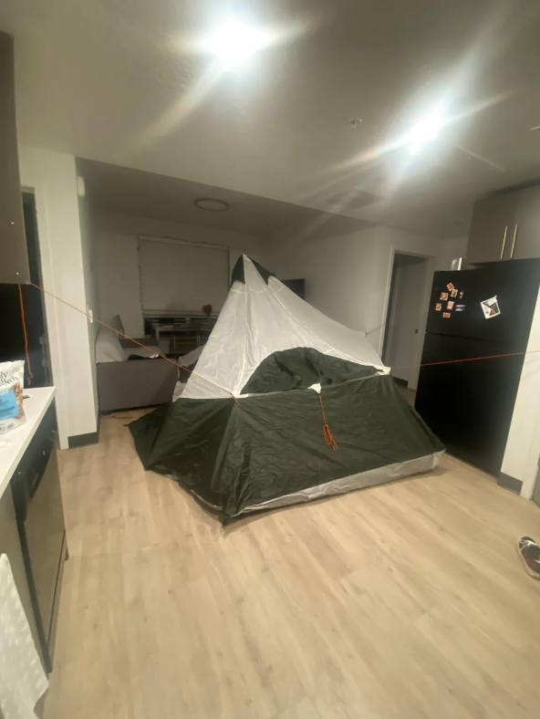 A large tent in the middle of a kitchen and living room space