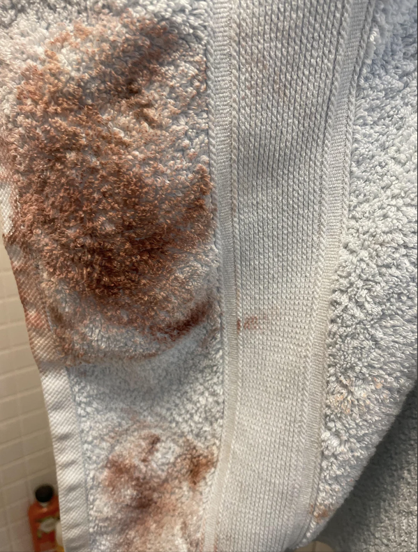 A towel with makeup stains on it