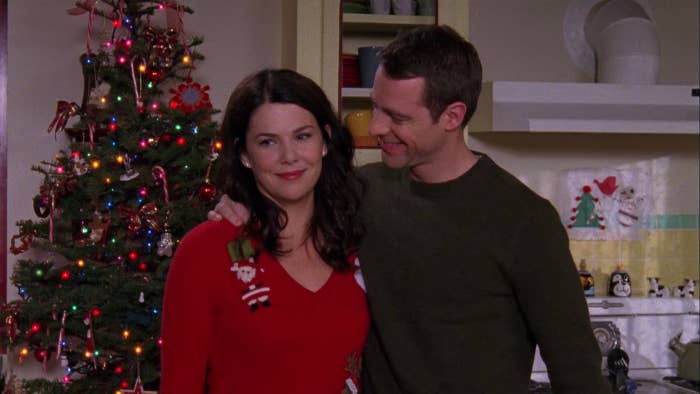 Christopher smiles and places his hand around Lorelai&#x27;s shoulder
